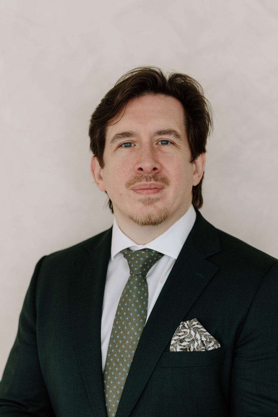 Professor David J McCormack, portrait in a green suit and tie